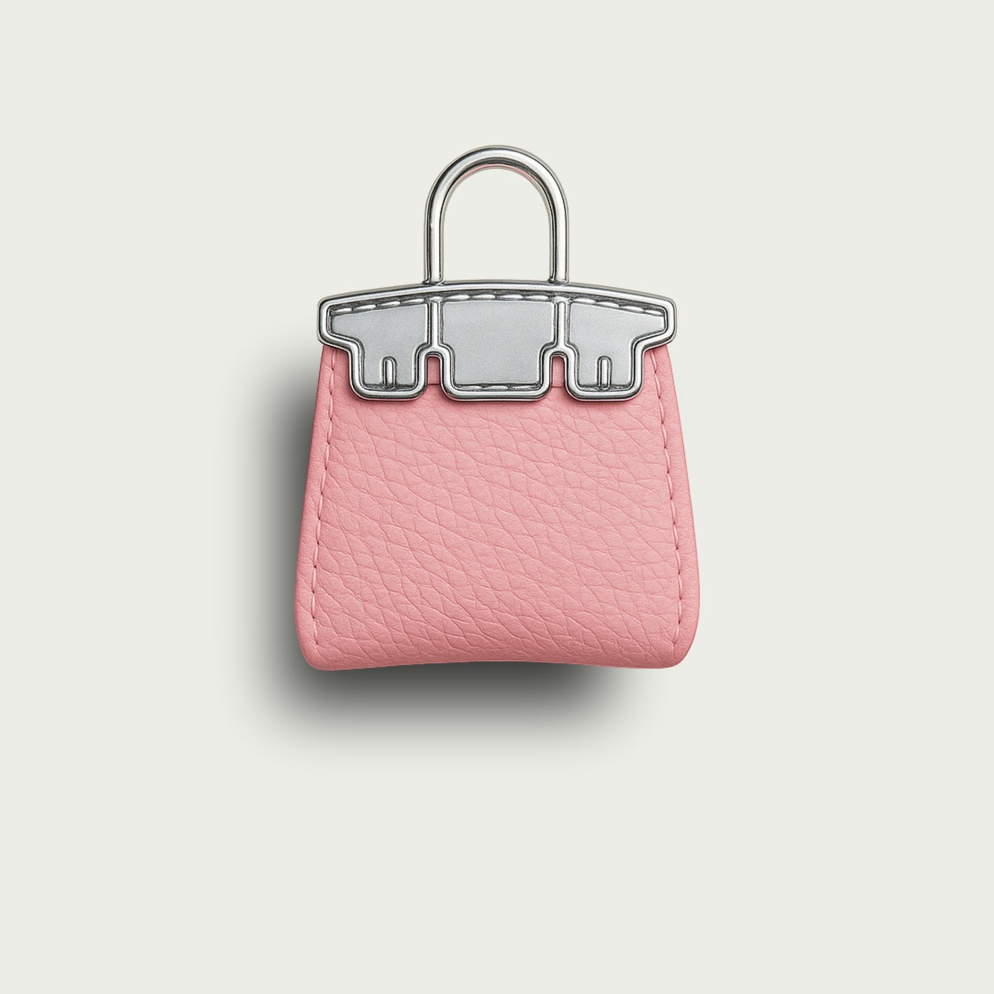 Porte-clés Mimi en forme de sac à main rose, cuir texturé et finitions en argent.