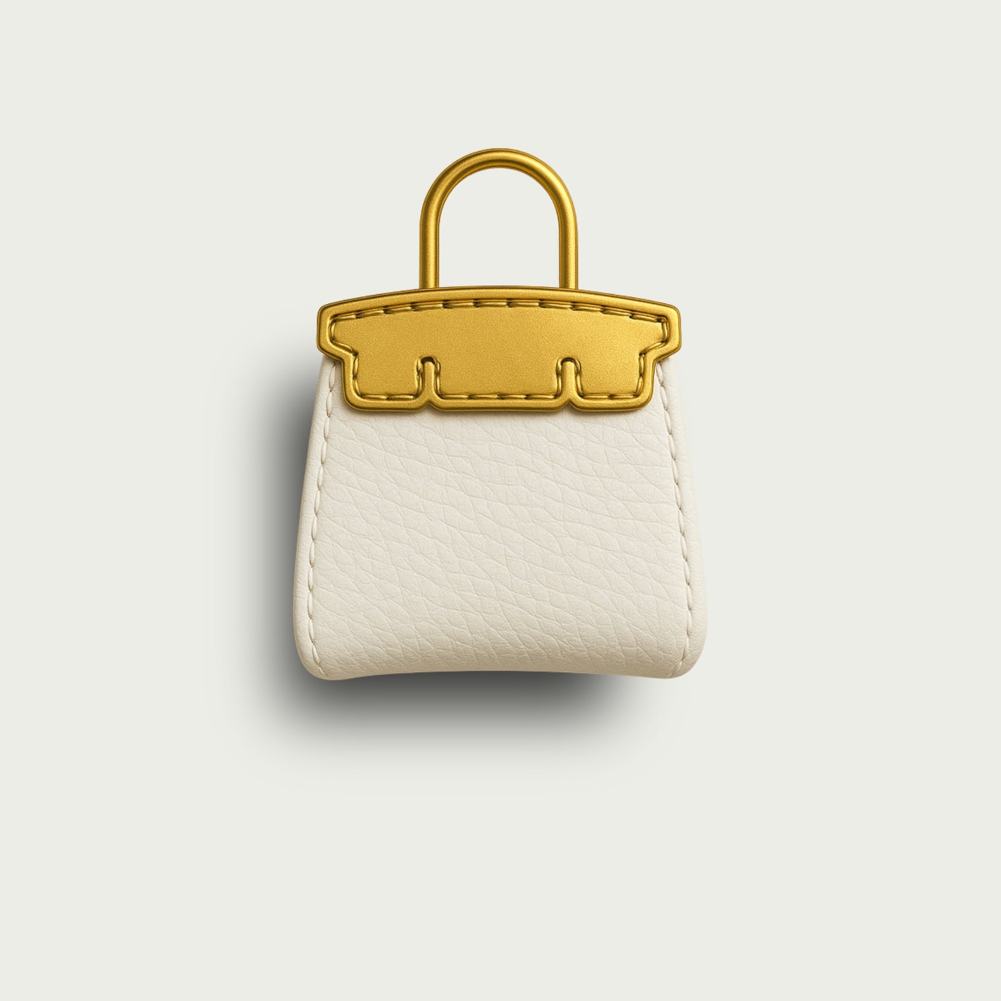 Vue de face du bijou Mimi, reproduction miniature d’un sac de luxe en cuir blanc, anse dorée.