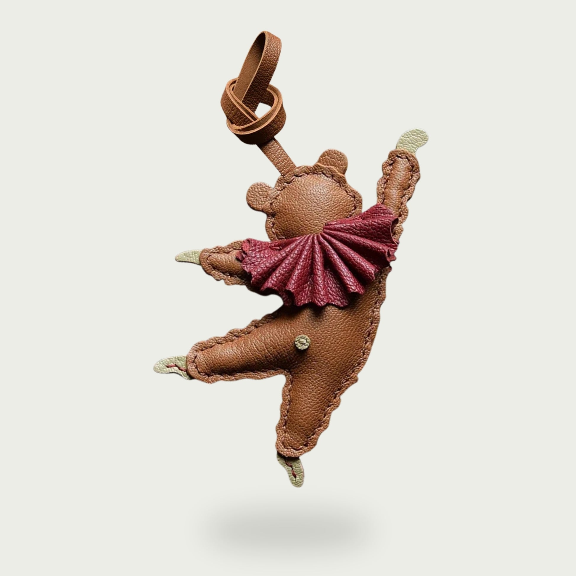 Vue arrière du bijou de sac ours en cuir marron, avec attache en lanière de cuir et finitions détaillées.